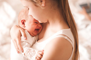 bigstock Young Mother Holding Crying Ba 330431692 SM